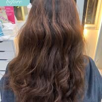 Client's long wavy hair before a smoothing service