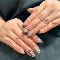 Silver and neutral glitter manicure with dimensional nail art